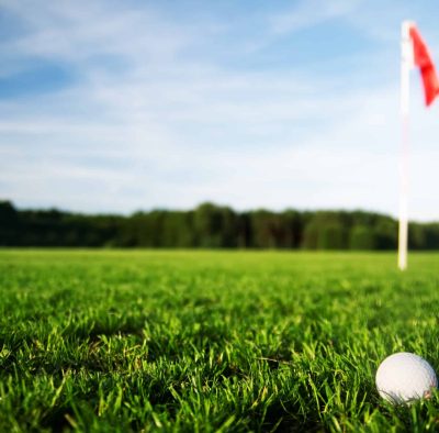 Golf field Golf field with green grass and red flag.